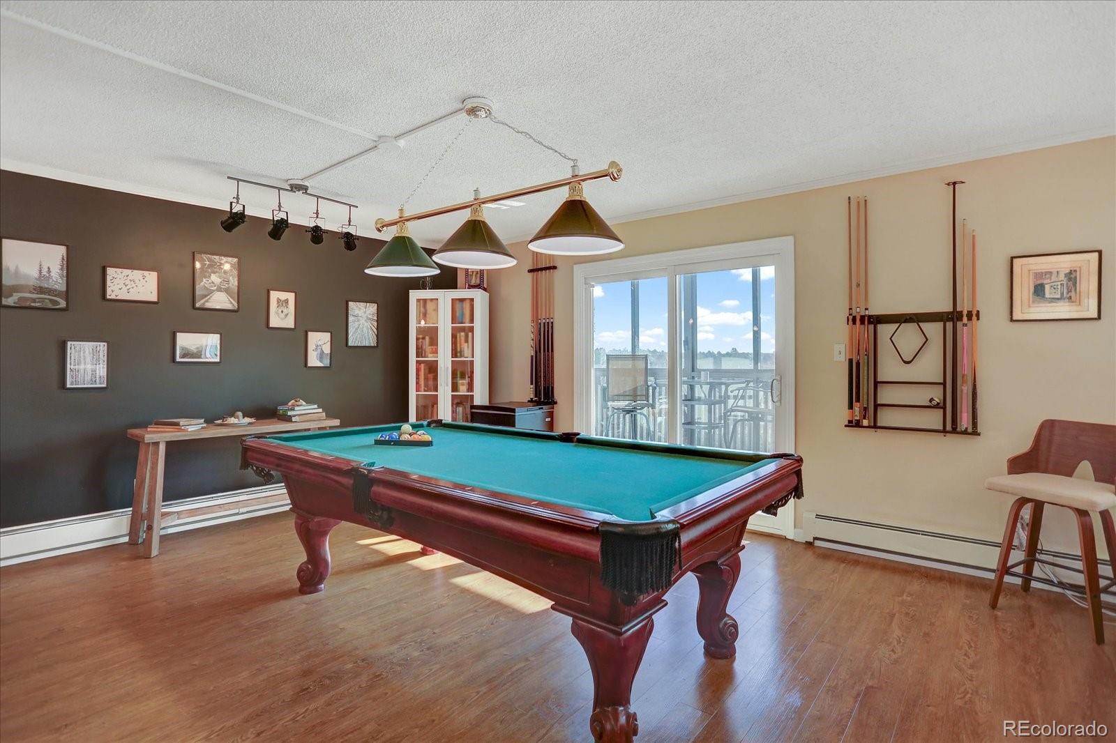 7040 East Girard Avenue, Unit E406 Denver, CO 80224 - Photo 6 of 27 a room with pool table and windows