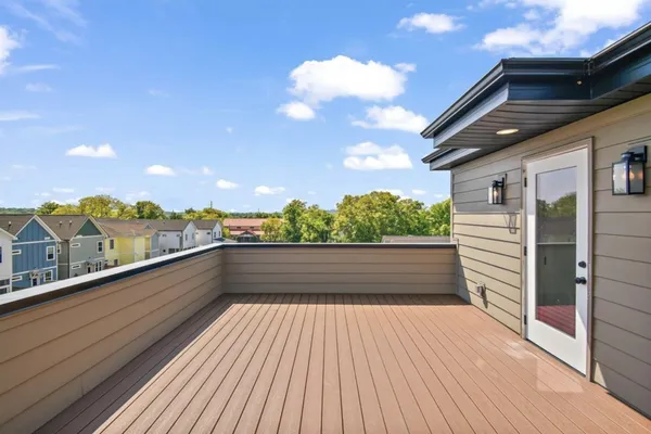 a view of balcony with couch and wooden floor