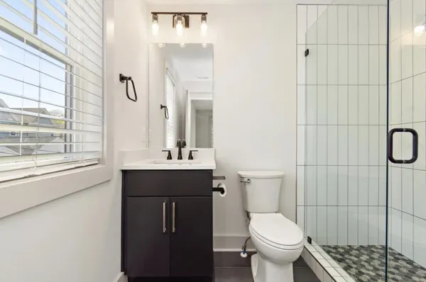 a bathroom with a sink toilet and shower