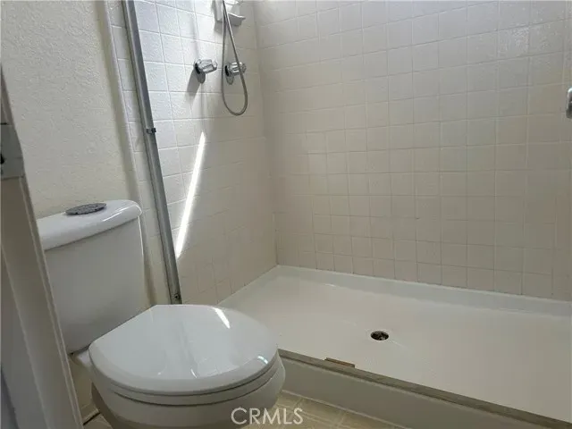 an empty room with a windows and closet