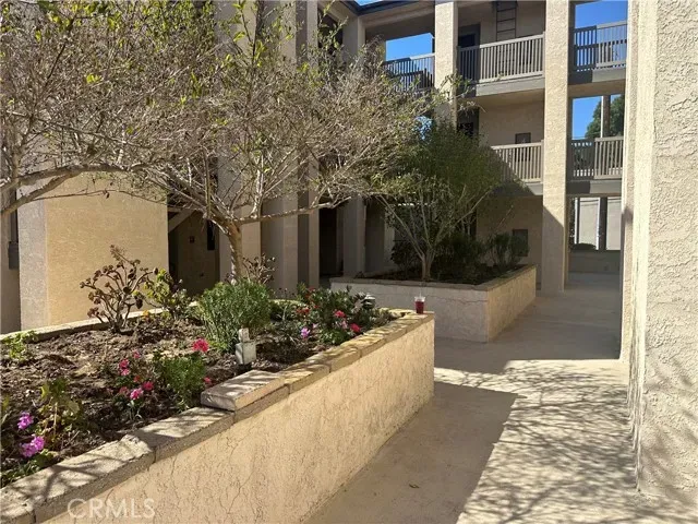 a hallway with wooden floor and chandelier