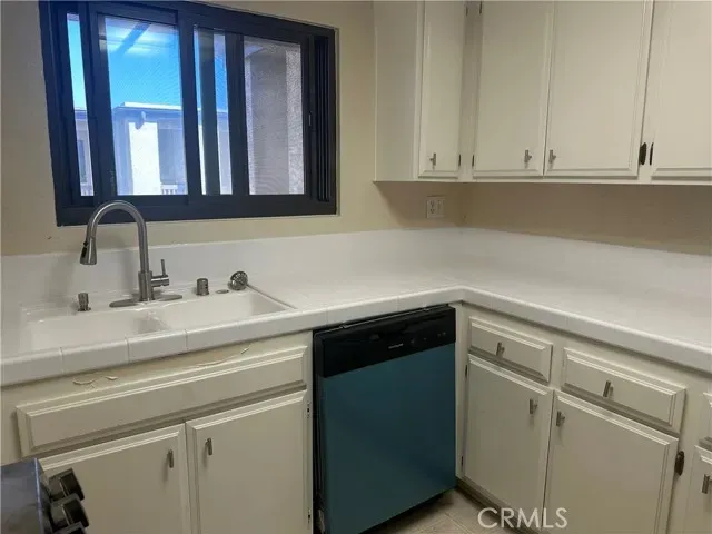 a stove top oven sitting inside of a kitchen