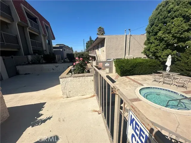 a view of a street with of cars parked on the roadside
