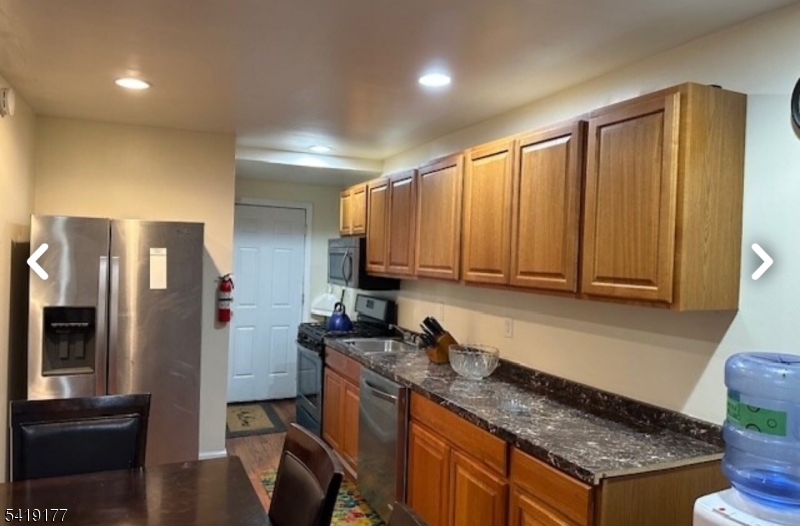 170 Fairmount Avenue Newark, NJ 07103 - Photo 3 of 8 a kitchen with stainless steel appliances granite countertop a refrigerator a stove and a sink