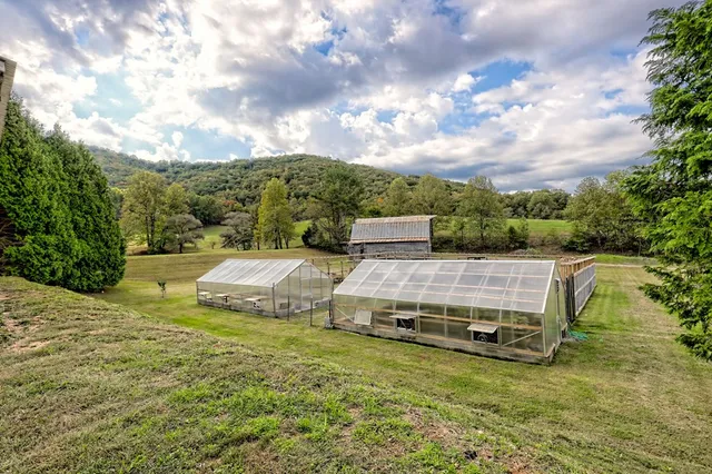 a view of house with outdoor space and swimming pool