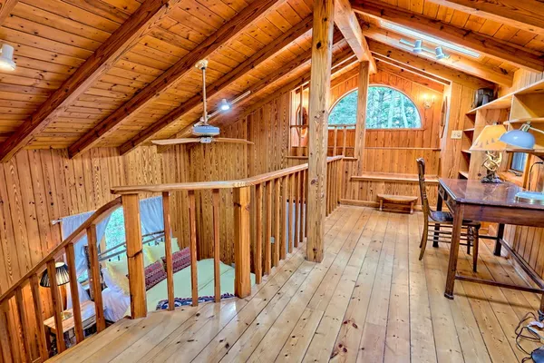 a bedroom with furniture and wooden floor