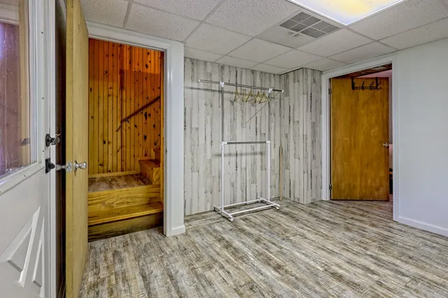 a view of a garden with a bench in the background