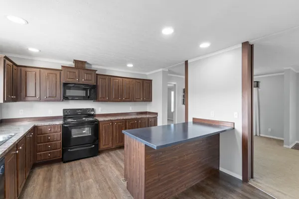 a kitchen with stainless steel appliances granite countertop a stove a sink and a refrigerator