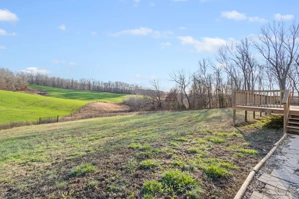 a view of a field with an trees in the background