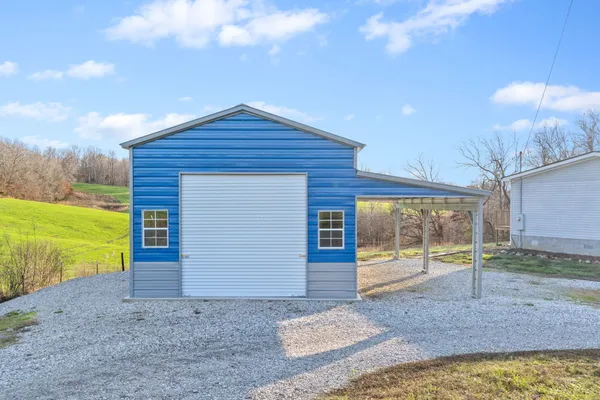 a view of a house with a yard and garage