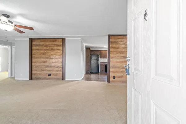 a view of a hallway with wooden shelves