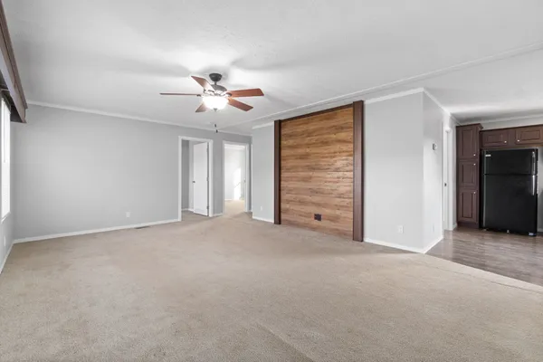 a view of an empty room with a ceiling fan