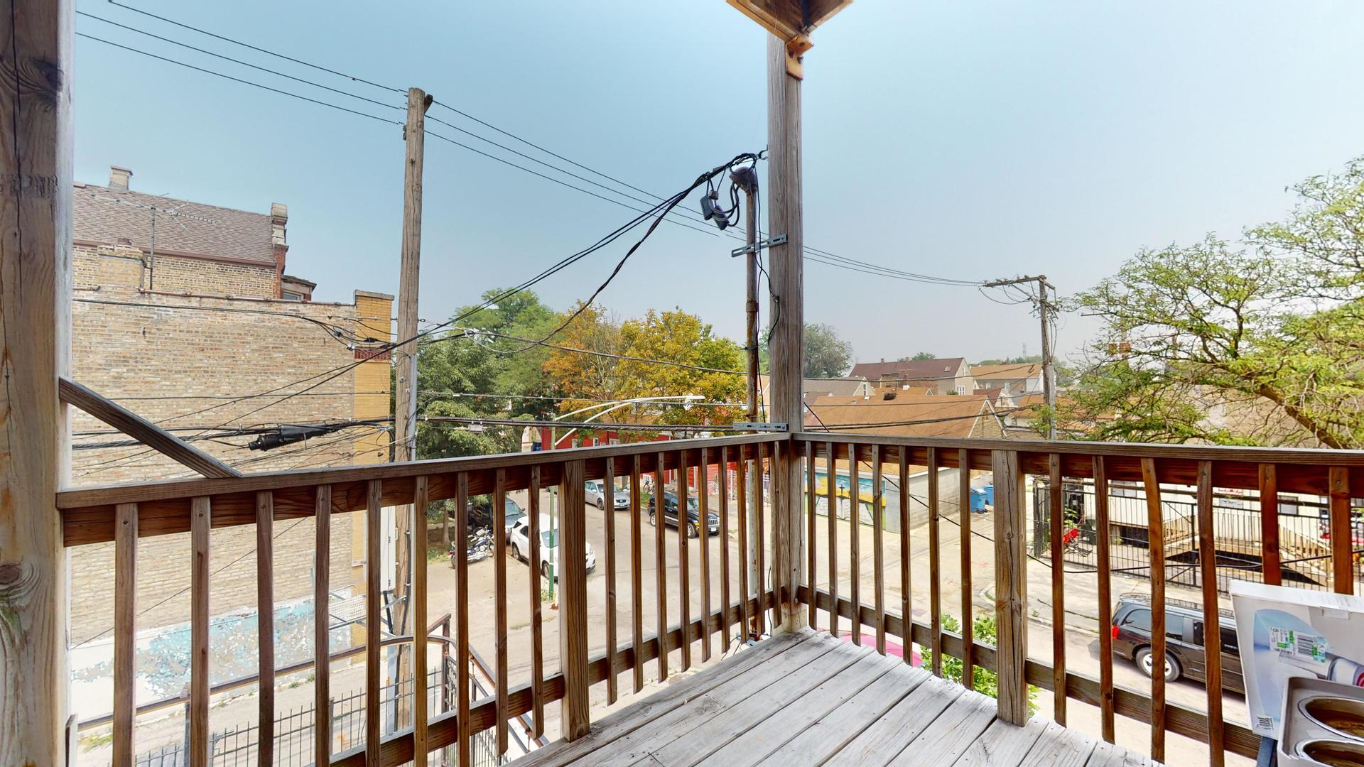 2700 West Cermak Road, Unit 2R Chicago, IL 60608 - Photo 14 of 15 a view of a balcony with wooden floor