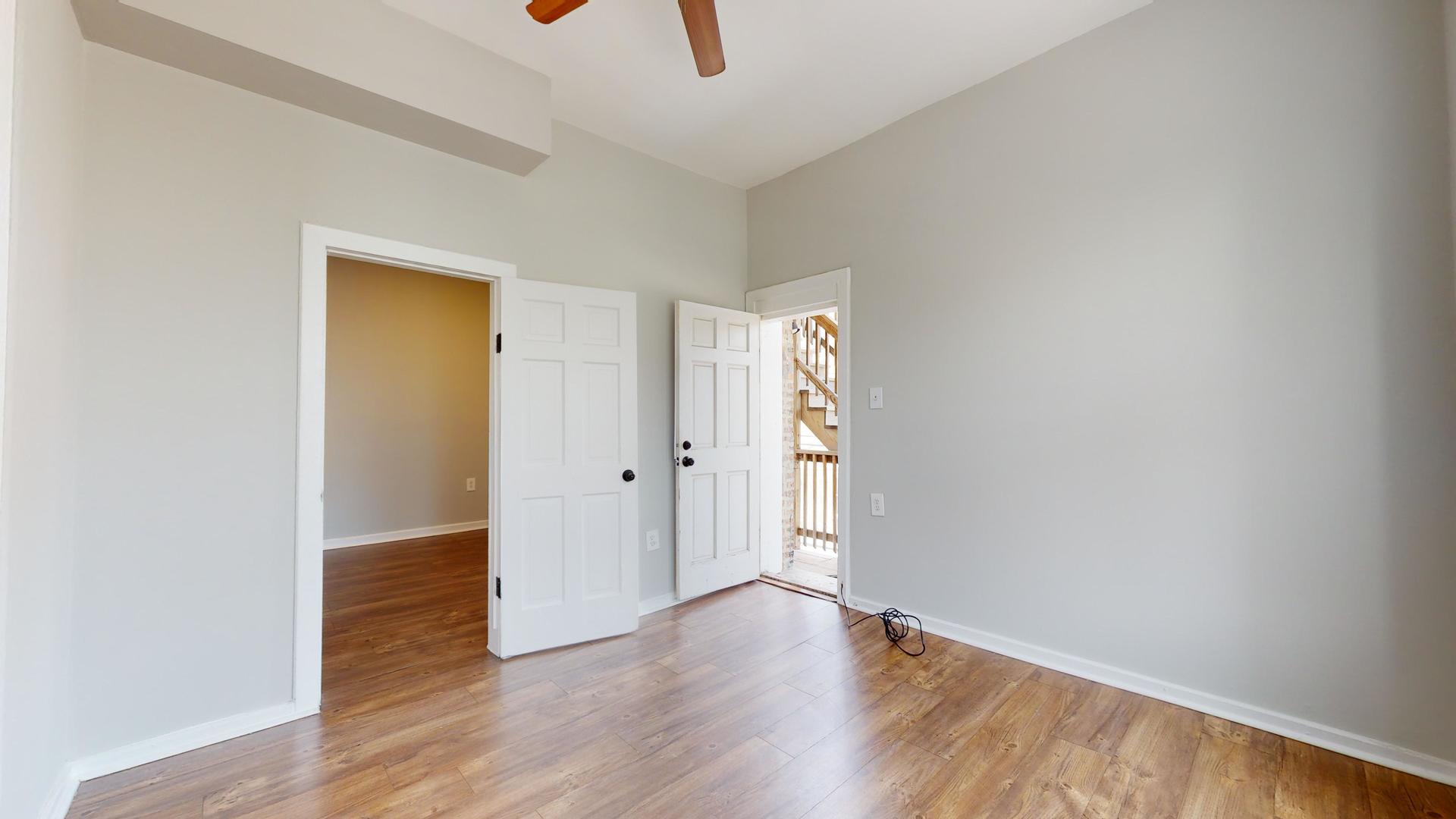 2700 West Cermak Road, Unit 2R Chicago, IL 60608 - Photo 3 of 15 a view of an empty room with wooden floor