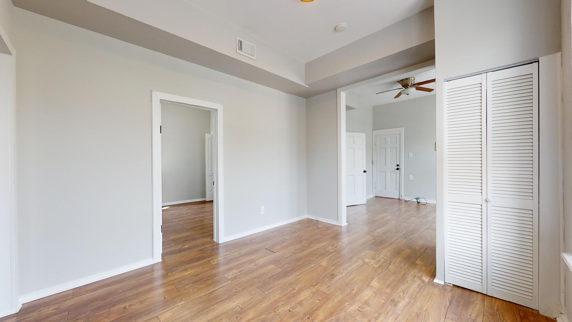 2700 West Cermak Road, Unit 2R Chicago, IL 60608 - Photo 5 of 15 a view of empty room with wooden floor and fan