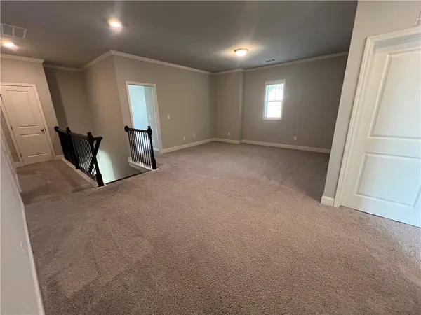 a view of an empty room with windows