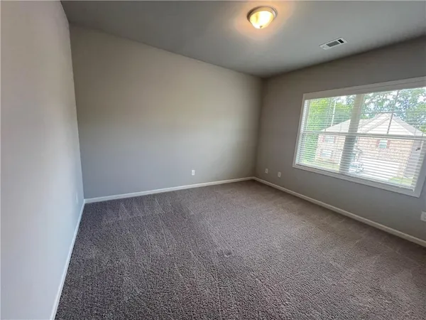an empty room with windows and entrance