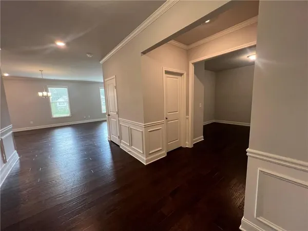 a view of a livingroom with wooden floor and a window