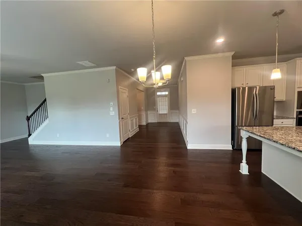 a view of a kitchen with a sink and refrigerator