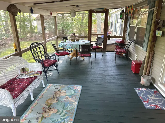a living room with furniture and floor to ceiling windows
