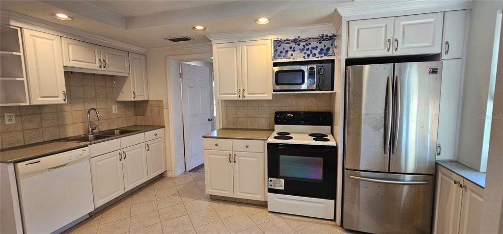 3125 19th Street North St. Petersburg, FL 33713 - Photo 3 of 14 a kitchen with stainless steel appliances and refrigerator