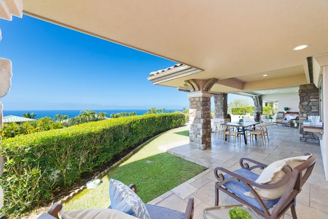 a view of a patio with dining table and chairs with a yard