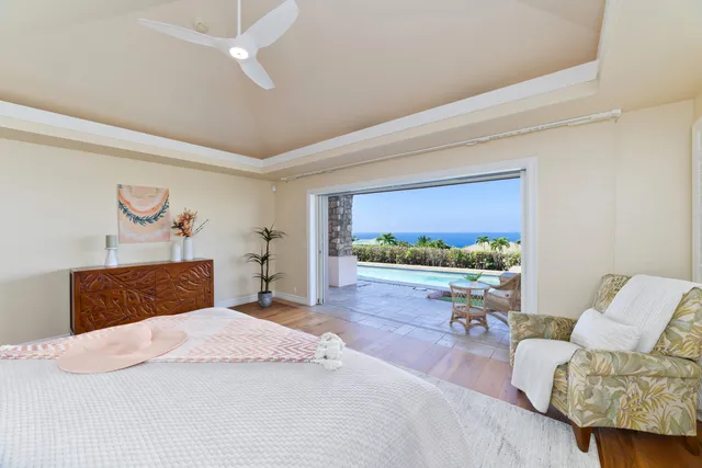 a bedroom with a bed and a large window with balcony view