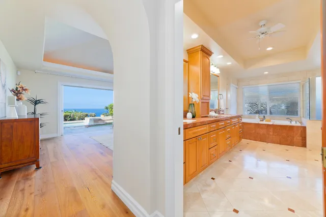a large white kitchen with a large window