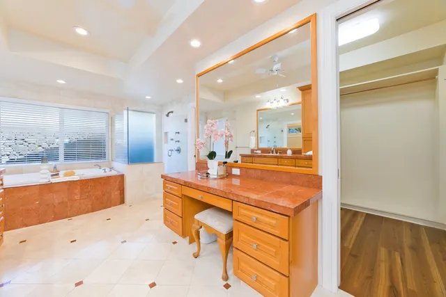 a large bathroom with a large tub and sink