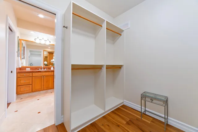 a living room with furniture kitchen view and a chandelier