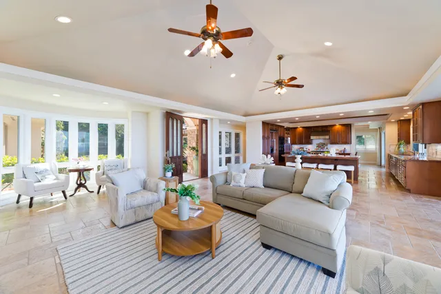 a living room with fireplace furniture and a rug