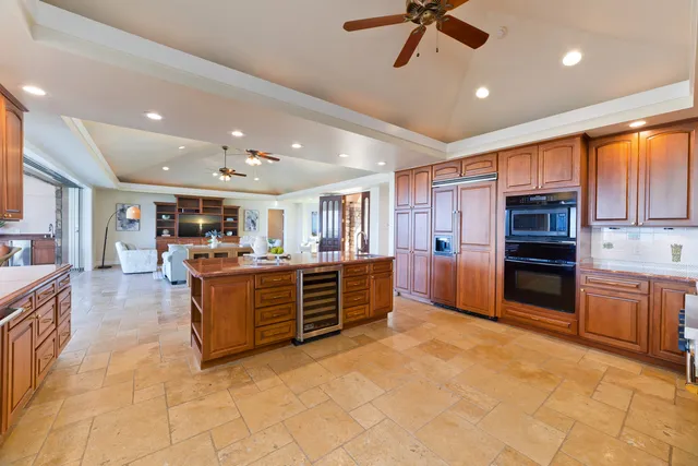 a large kitchen with cabinets and stainless steel appliances