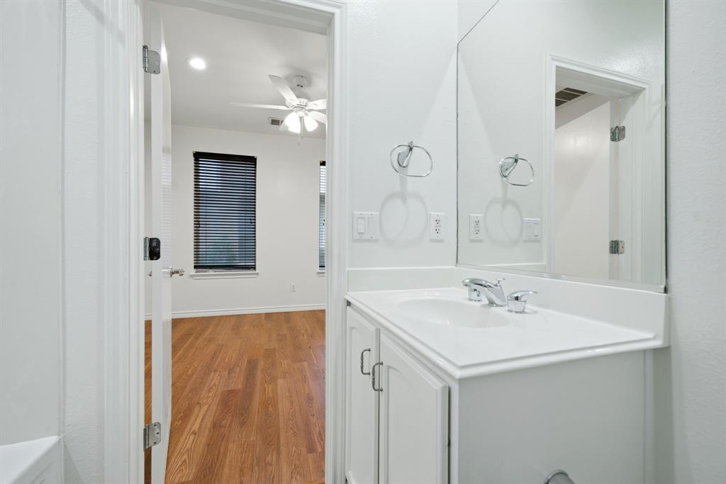 4330 McKinney Avenue, Unit 16 Dallas, TX 75205 - Photo 27 of 34 White cabinetry and countertop in first floor bathroom.