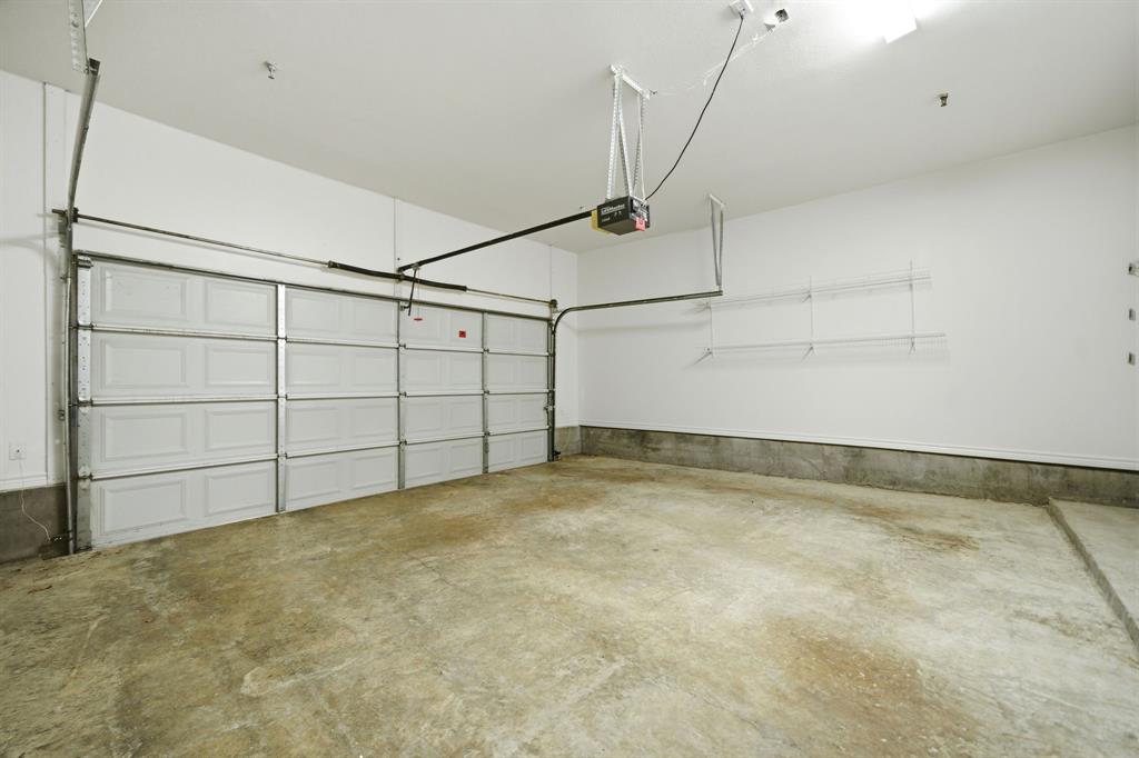 4330 McKinney Avenue, Unit 16 Dallas, TX 75205 - Photo 30 of 34 Attached two car garage is wide enough for shelving on the side wall.