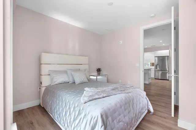 a bedroom with a bed and glass door