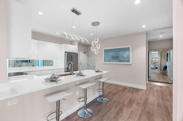 a spacious bathroom with a granite countertop sink a mirror and shower