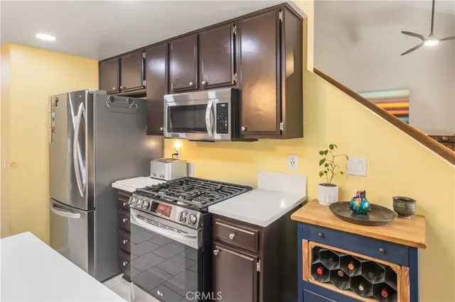 a kitchen with stainless steel appliances granite countertop a refrigerator and a stove