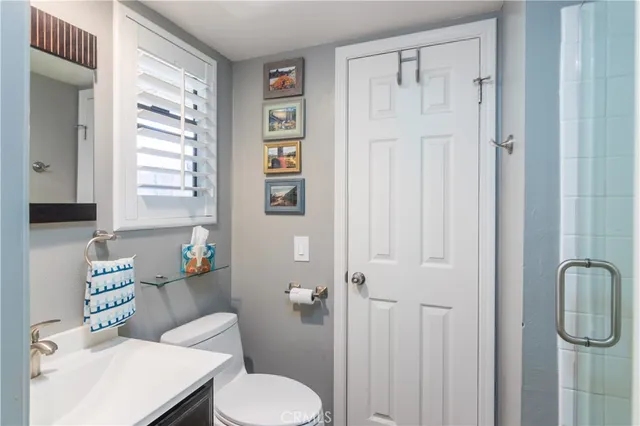 a white toilet sitting next to a bathroom sink