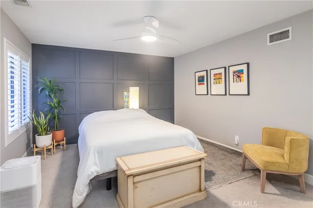 a bedroom with a bed and chair