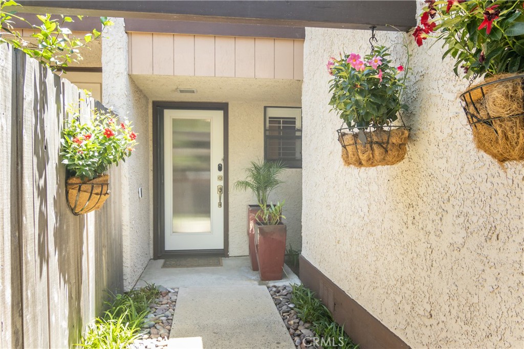 24831 Apple Street, Unit B Newhall, CA 91321 - Photo 2 of 37 a front view of a house with flowers