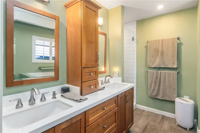 a bathroom with a double vanity sink and a mirror