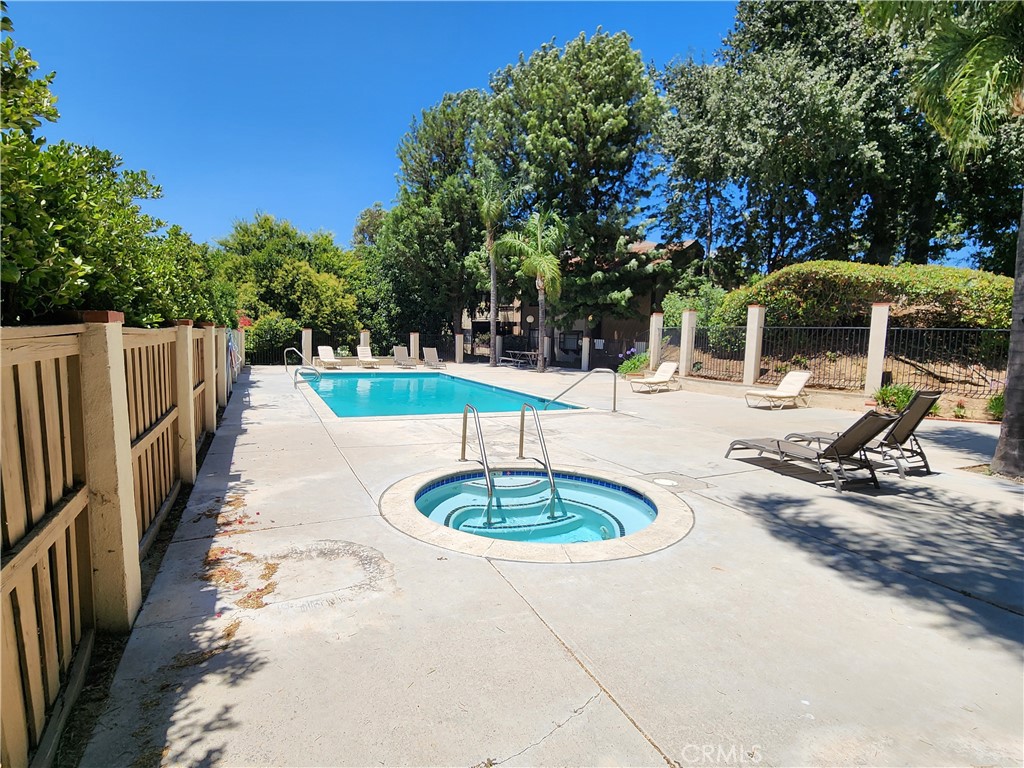 24831 Apple Street, Unit B Newhall, CA 91321 - Photo 32 of 37 a swimming pool with outdoor seating and trees
