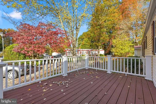 a balcony with wooden floor and fence
