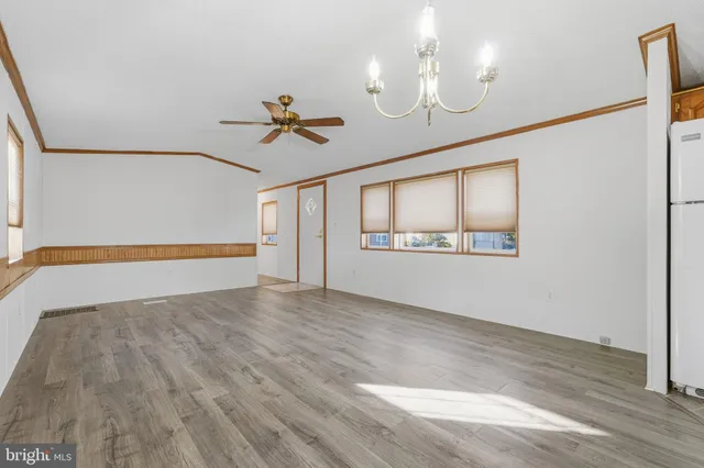 a view of an empty room window and wooden floor