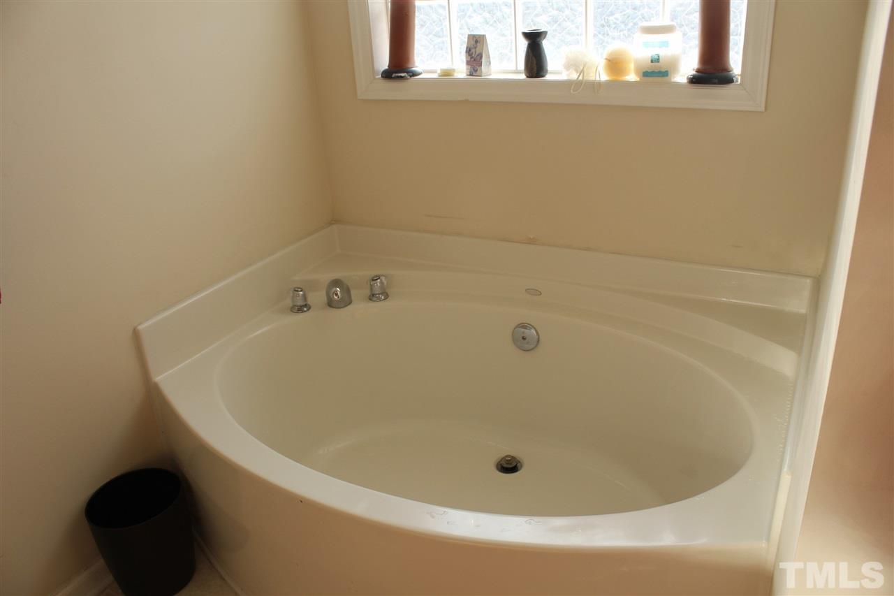 3134 Rendezvous Drive Raleigh, NC 27610 - Photo 14 of 20 a white bath tub sitting in a bathroom