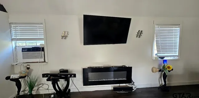 a living room with furniture and a flat screen tv