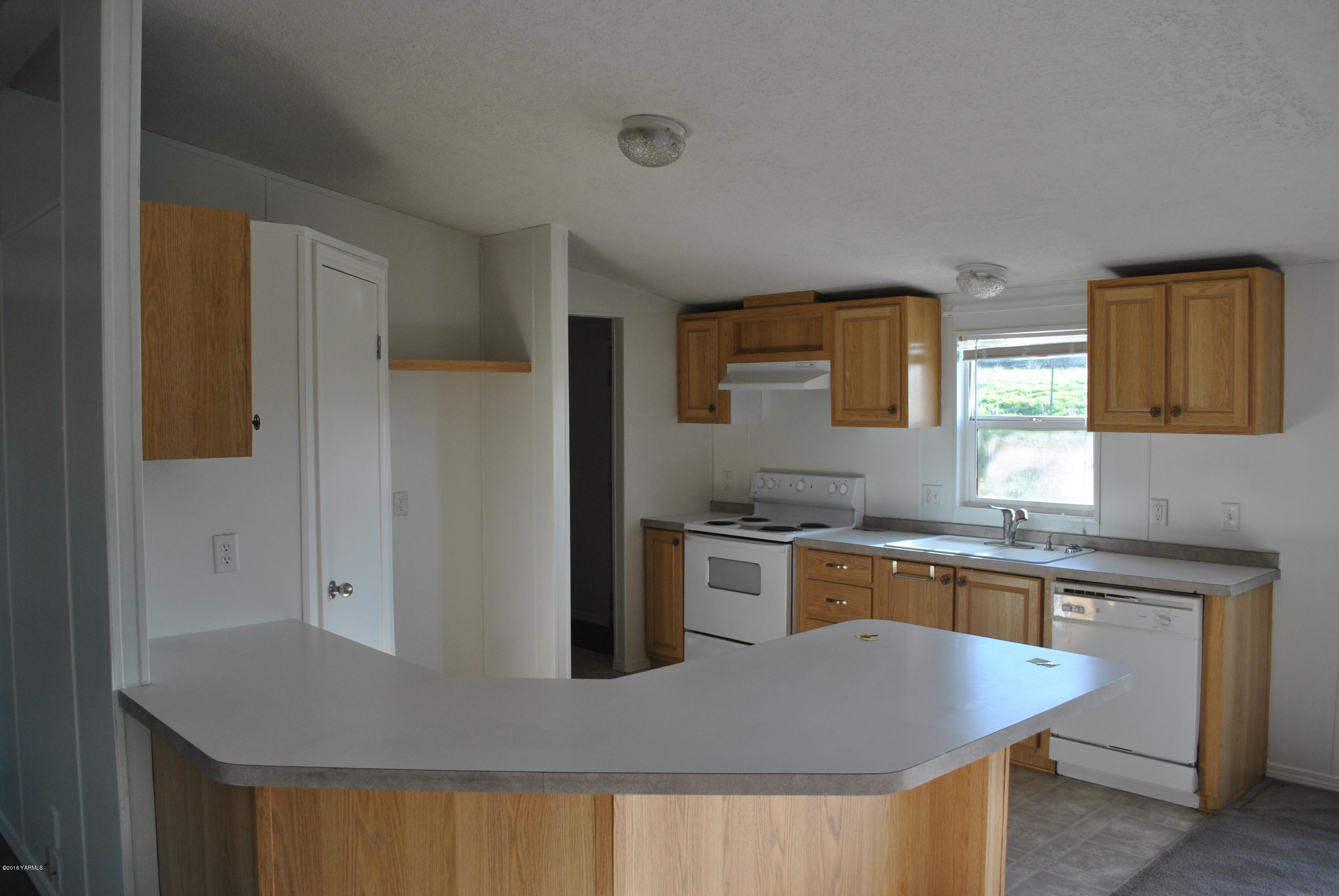 1153 Tear Road Grandview, WA 98930 - Photo 2 of 6 a kitchen with stainless steel appliances granite countertop a sink a stove and a refrigerator
