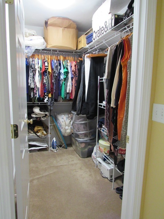 185 Burbank Road Sutton, MA 01590 - Photo 13 of 30 a view of walk in closet with clothes and shoes