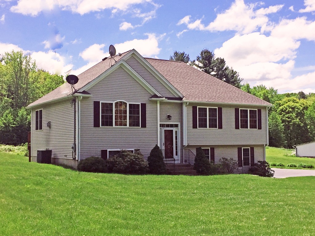 185 Burbank Road Sutton, MA 01590 - Photo 2 of 30 a front view of a house with a garden