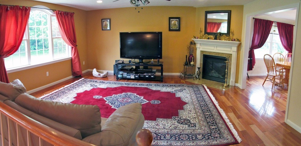 185 Burbank Road Sutton, MA 01590 - Photo 5 of 30 a living room with a flat screen tv and a fireplace